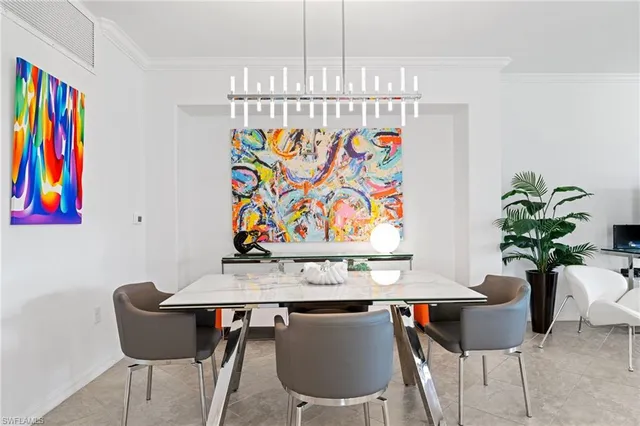 a view of a dining room with furniture and a chandelier