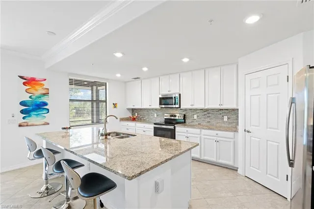 a kitchen with kitchen island granite countertop a sink and center island