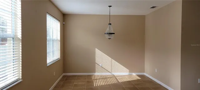 a view of an empty room with windows