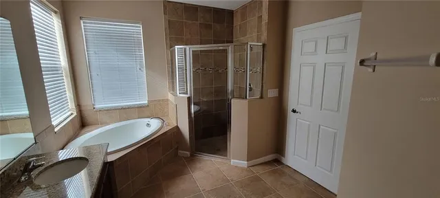 a bathroom with a tub and a sink