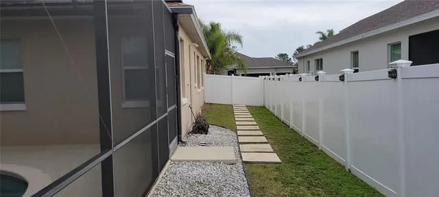 a view of a house with wooden fence