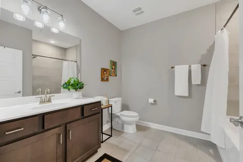 a bathroom with a sink toilet and mirror