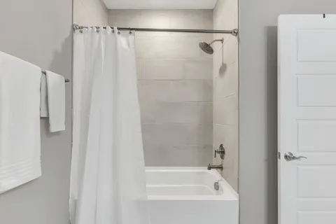 a bathroom with a shower and a bath tub