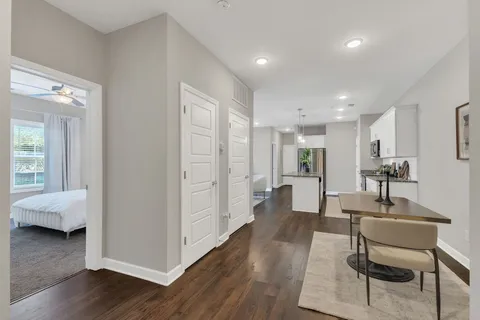 a living room with furniture and a wooden floor