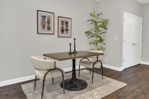 a dining room with furniture and wooden floor