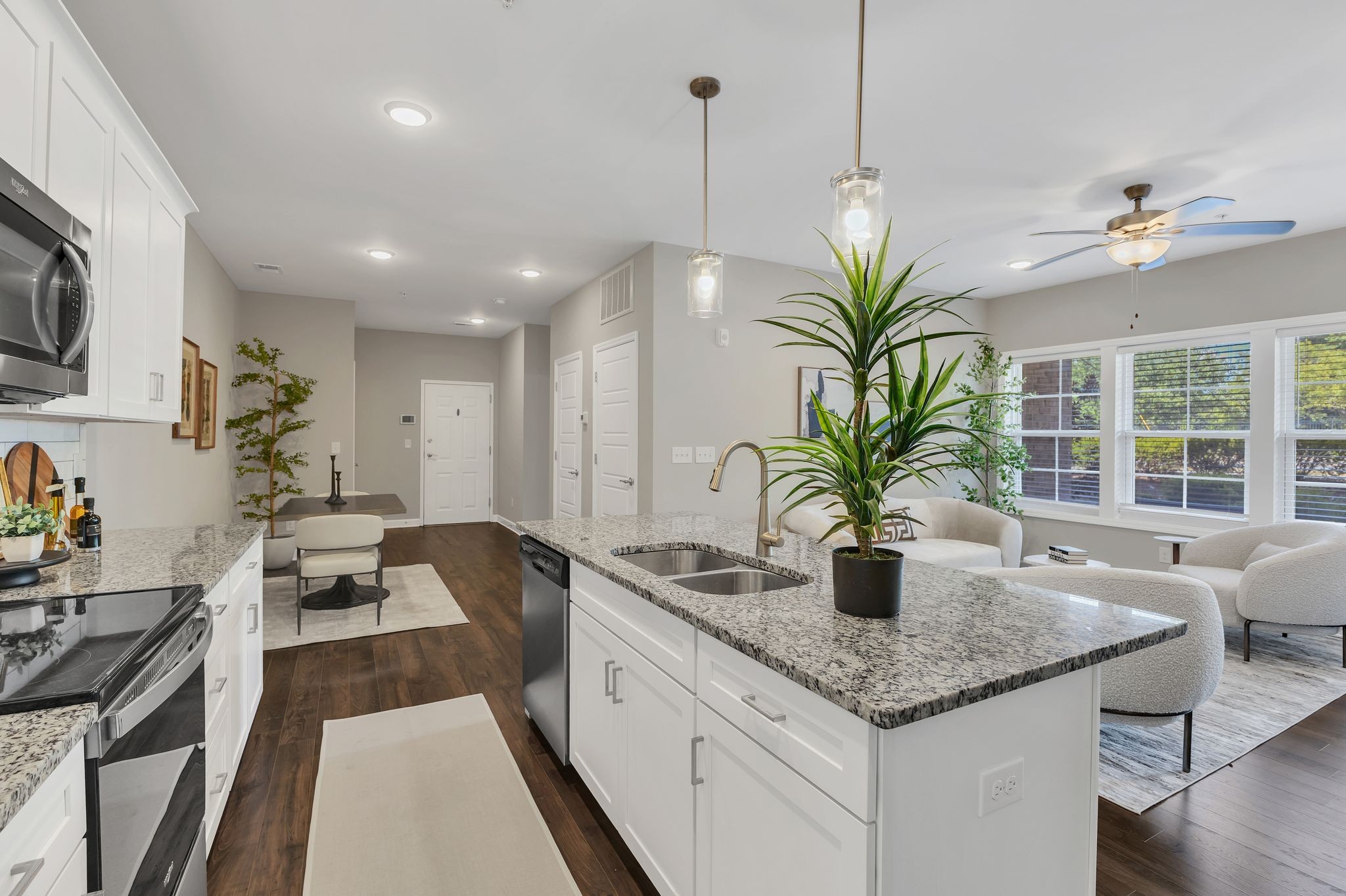 7487 Highway 70 South, Unit 101 Nashville, TN 37221 - Photo 10 of 20 a kitchen with granite countertop a sink a counter top space and living room view
