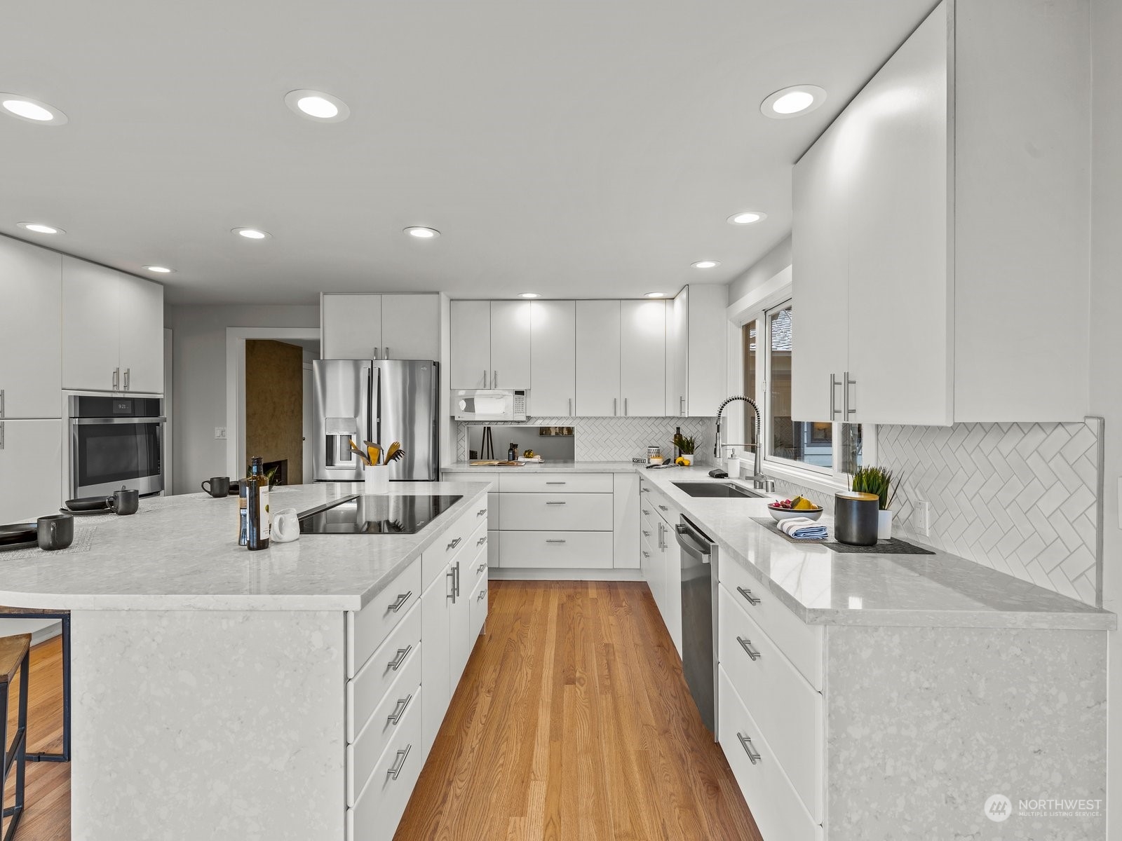 750 Northstream Lane Edmonds, WA 98020 - Photo 12 of 37 a large white kitchen with stainless steel appliances lots of counter space and a sink