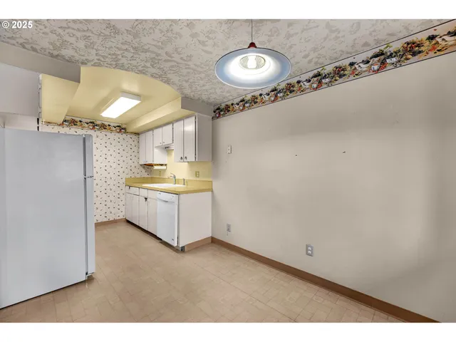 a kitchen with a refrigerator and a stove