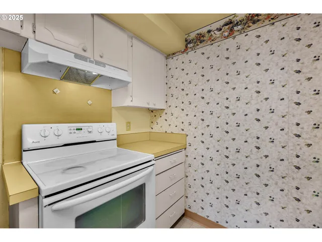 a utility room with a stove top oven