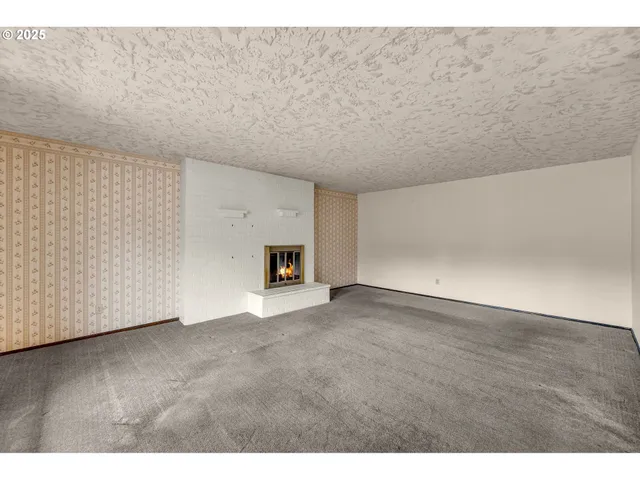 a view of an empty room with fire place