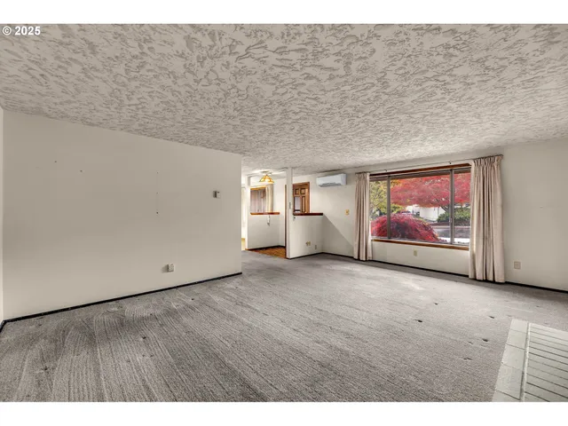 a view of an empty room with painting on the wall