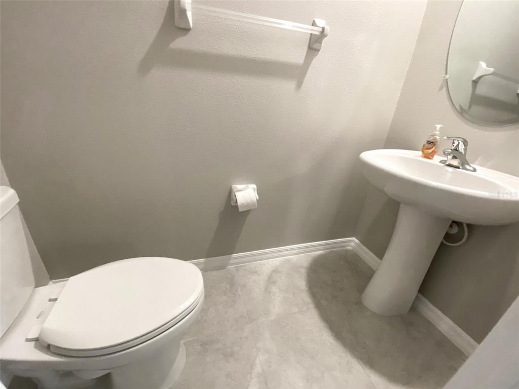 3816 Hanover Drive New Port Richey, FL 34653 - Photo 21 of 64 a bathroom with a sink a toilet and mirror