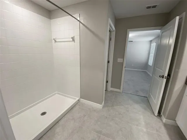 a view of a hallway with closet and wooden floor