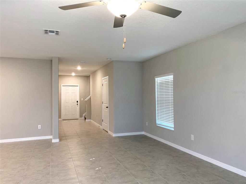 3816 Hanover Drive New Port Richey, FL 34653 - Photo 3 of 64 an empty room with windows and cabinet