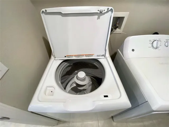 a bathroom with a granite countertop sink a mirror and a bathtub