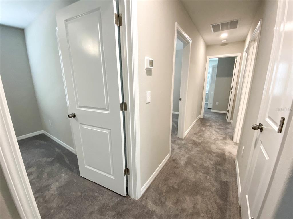 3816 Hanover Drive New Port Richey, FL 34653 - Photo 38 of 64 a view of a hallway with closet and wooden floor