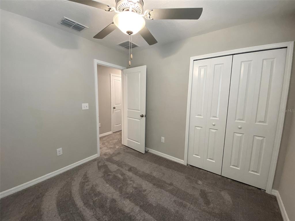 3816 Hanover Drive New Port Richey, FL 34653 - Photo 39 of 64 an empty room with closet and a chandelier fan
