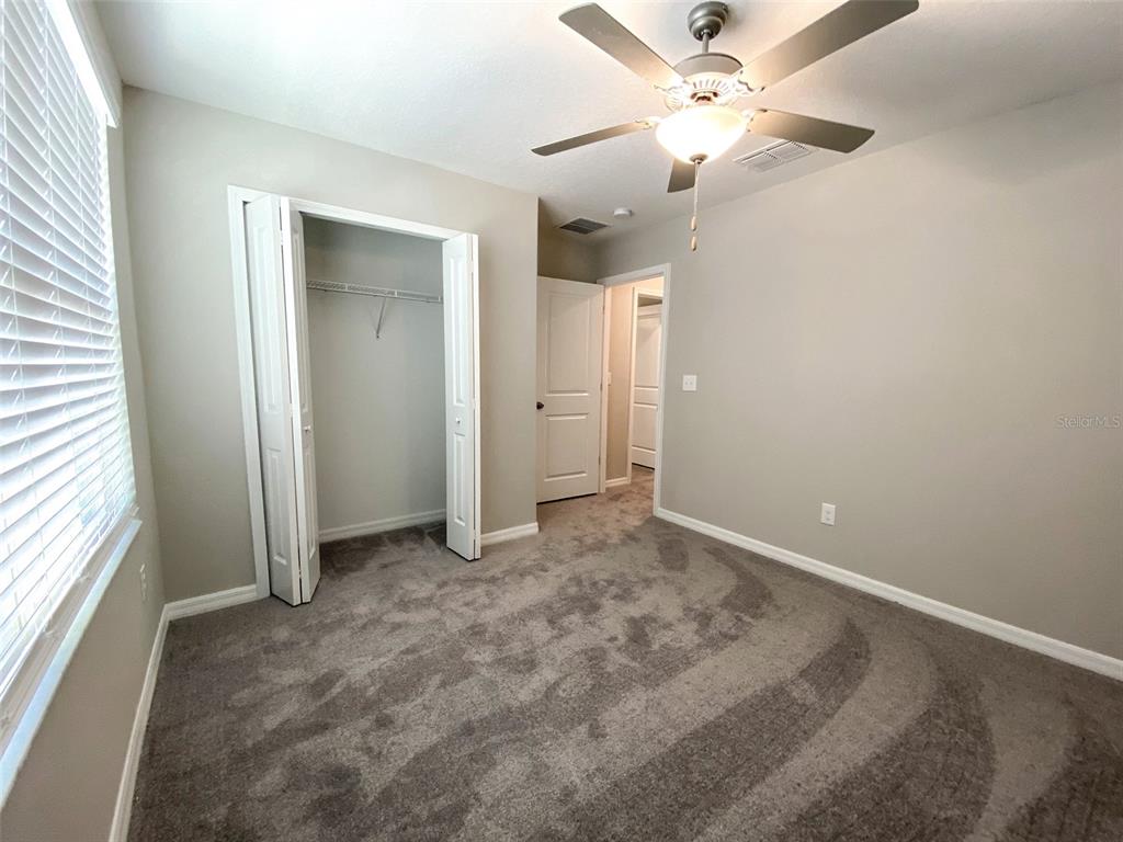 3816 Hanover Drive New Port Richey, FL 34653 - Photo 40 of 64 an empty room with fan and a ceiling fan