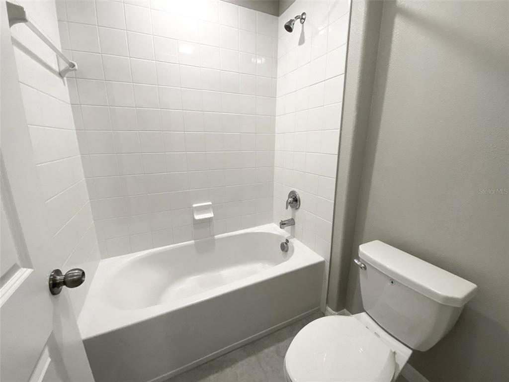 3816 Hanover Drive New Port Richey, FL 34653 - Photo 43 of 64 a white toilet sitting next to a bathtub