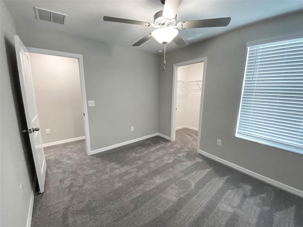 3816 Hanover Drive New Port Richey, FL 34653 - Photo 46 of 64 an empty room with windows and fan