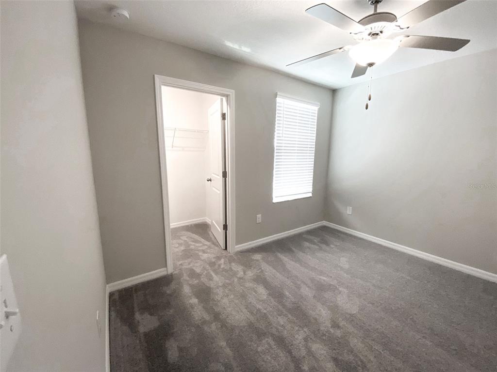 3816 Hanover Drive New Port Richey, FL 34653 - Photo 48 of 64 an empty room with a window and a fan