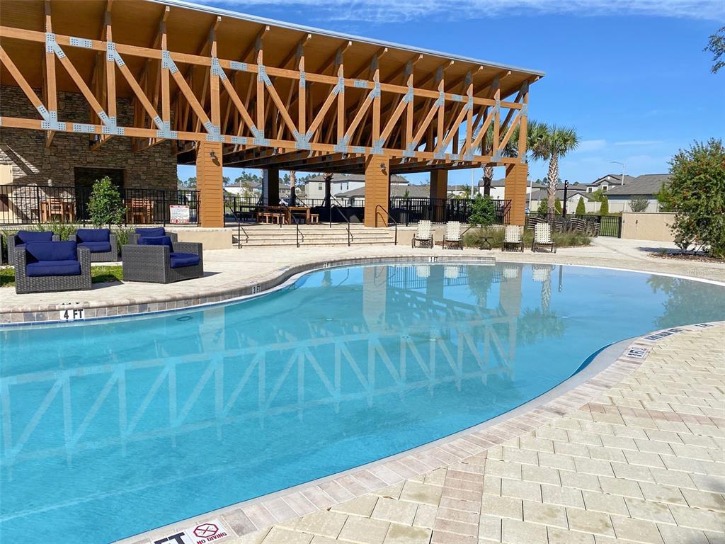 3816 Hanover Drive New Port Richey, FL 34653 - Photo 57 of 64 a view of a swimming pool with outdoor seating
