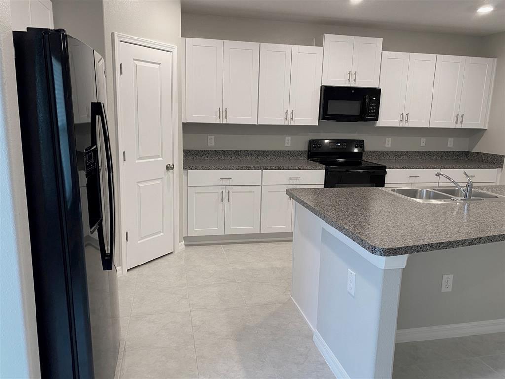 3816 Hanover Drive New Port Richey, FL 34653 - Photo 6 of 64 a kitchen with stainless steel appliances granite countertop a refrigerator stove and sink