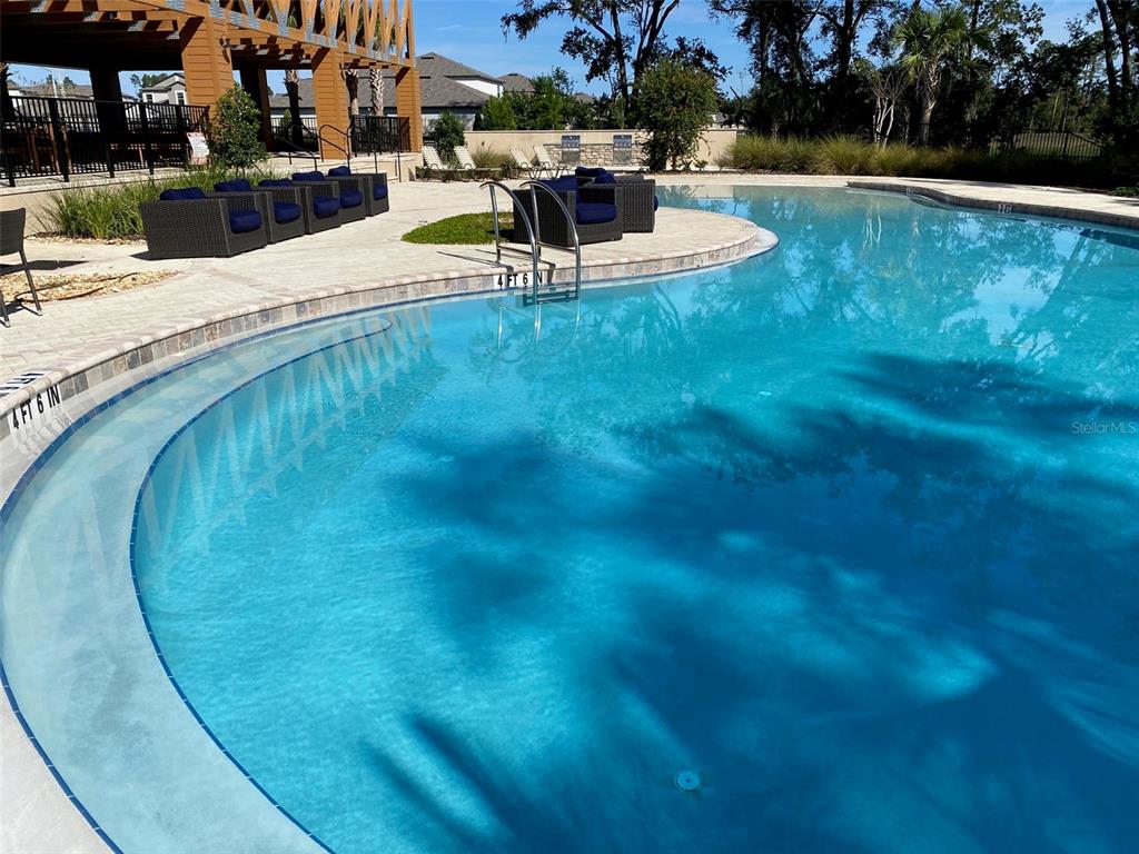 3816 Hanover Drive New Port Richey, FL 34653 - Photo 61 of 64 a view of a swimming pool with sitting area