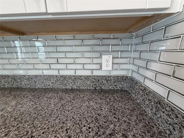 a kitchen with a refrigerator and cabinets