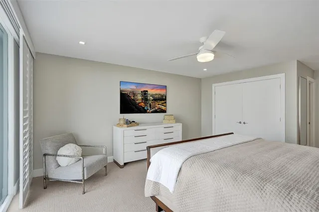 a bedroom with furniture and a flat screen tv