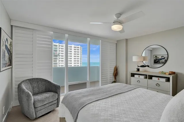 a bedroom with a bed a couch and dresser