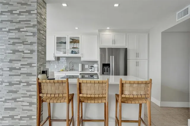a kitchen with stainless steel appliances a refrigerator and a stove top oven