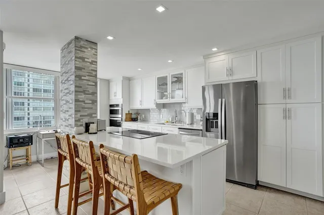 a kitchen with refrigerator and cabinets