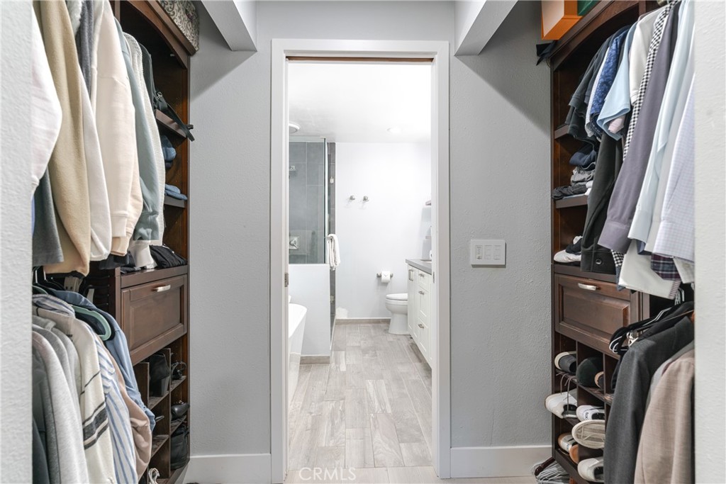 12 Juniper Irvine, CA 92612 - Photo 15 of 26 a view of walk in closet with clothes and shoes