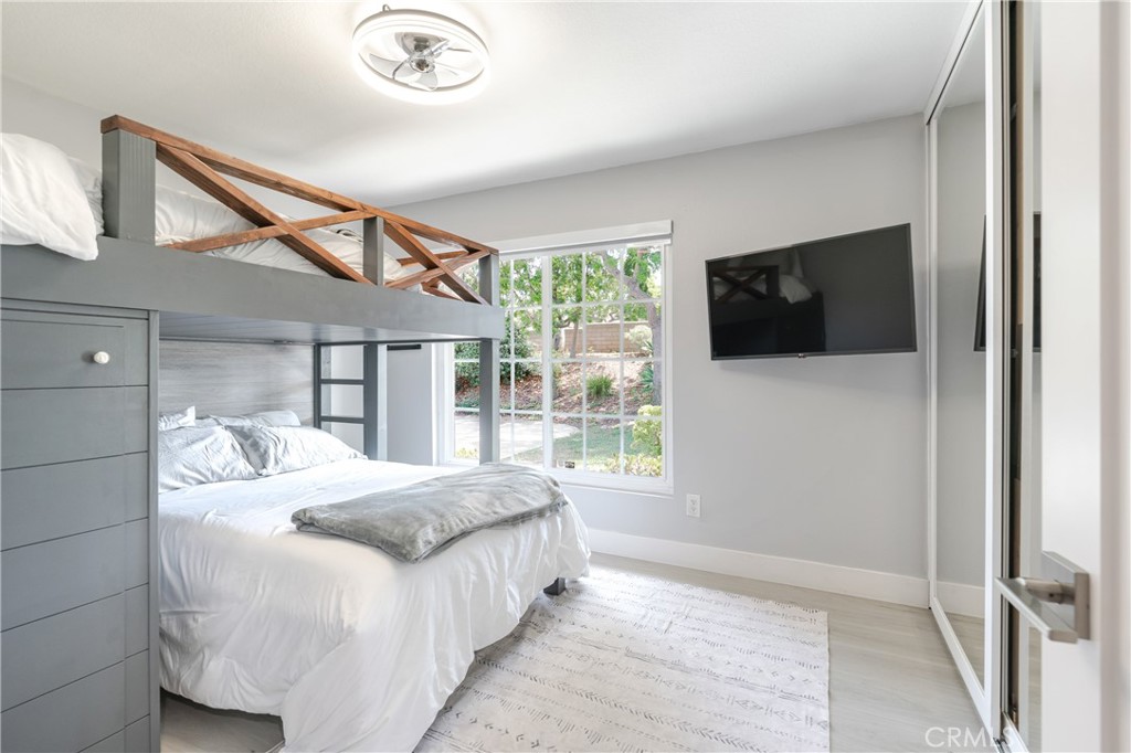 12 Juniper Irvine, CA 92612 - Photo 20 of 26 a bedroom with a bed and a flat screen tv