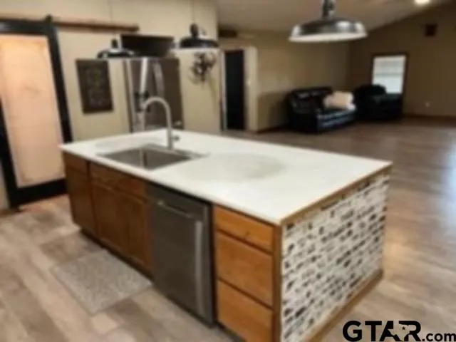 a kitchen with kitchen island a sink and a refrigerator
