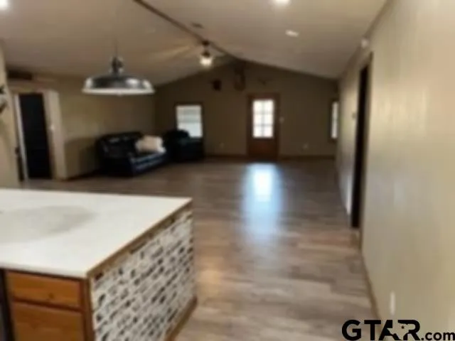 a view of a hallway with entryway wooden floor and front door