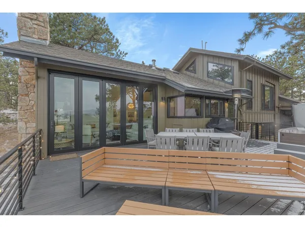 a view of a roof deck with table and chairs and wooden floor