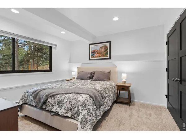 a bedroom with a bed and a painting on the wall