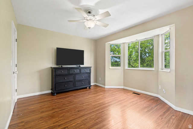 843 Deer Flat Road Tooele, UT 84074 - Photo 13 of 27 Bright room featuring wood-finish flooring and a ceiling fan with integrated lighting