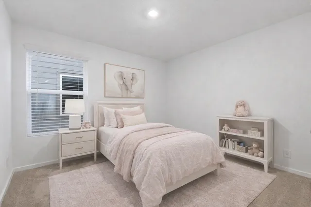 a bedroom with a bed and a window