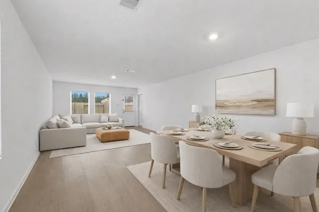 a dining room with furniture and wooden floor