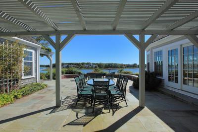 120 North Bay Road Osterville, MA 02655 - Photo 18 of 21 a view of a patio with table and chairs and floor to ceiling window with wooden floor