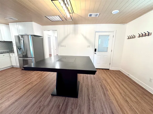 an empty room with wooden floor and a window