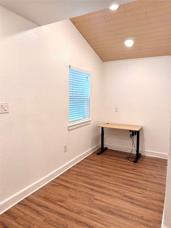 6011 Nuckols Crossing Road Austin, TX 78744 - Photo 15 of 24 Spare room featuring wood finished floors, crown molding, wooden ceiling, a textured wall, and recessed lighting