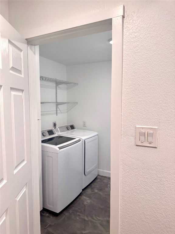 6011 Nuckols Crossing Road Austin, TX 78744 - Photo 16 of 24 Laundry room featuring a textured wall and washing machine and dryer