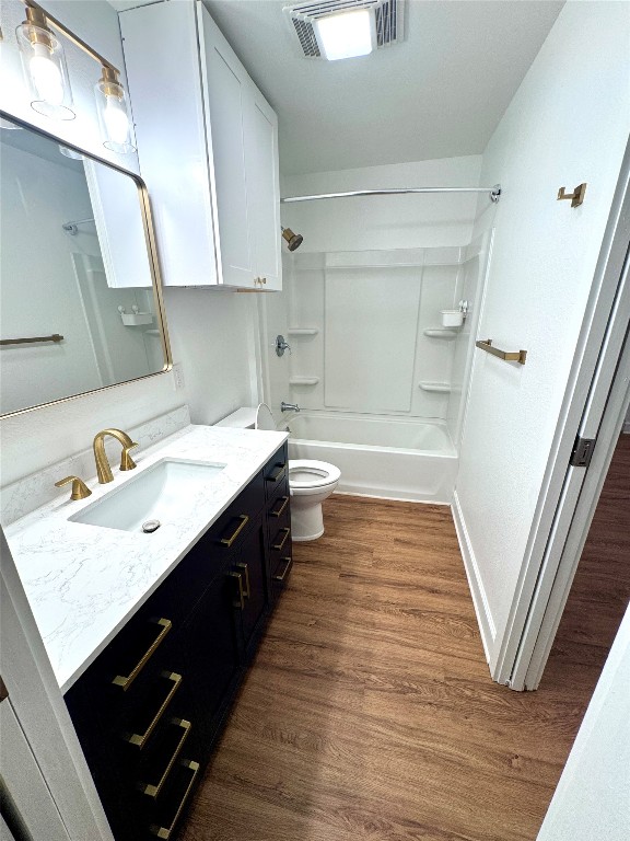 6011 Nuckols Crossing Road Austin, TX 78744 - Photo 17 of 24 Full bathroom with vanity, tub / shower combination, and dark wood finished floors