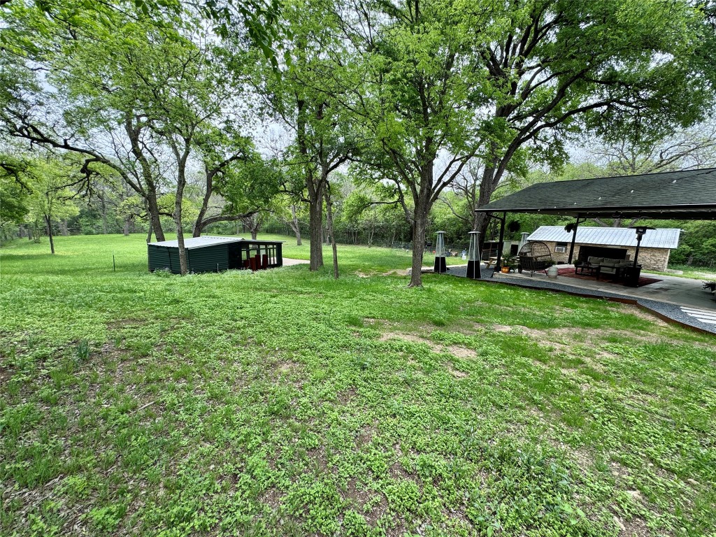 6011 Nuckols Crossing Road Austin, TX 78744 - Photo 5 of 24 View of grassy yard featuring a chicken coop.