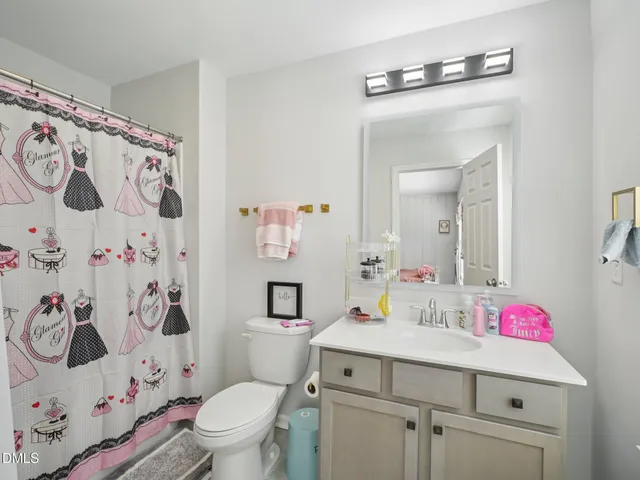 a bathroom with a sink toilet vanity and tub