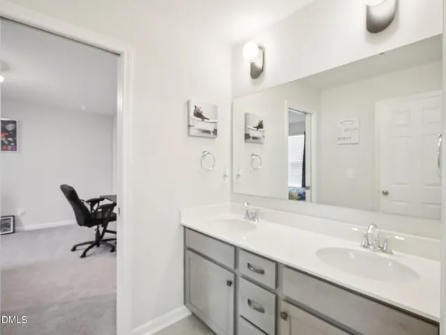 a bathroom with a double vanity sink